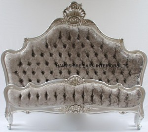 A CANNES ORNATE BED IN SILVER LEAF WITH SILVER MERCURY CRUSHED VELVET AND CRYSTAL BUTTONS